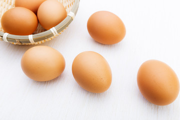 Fresh brown and white eggs on white cloth