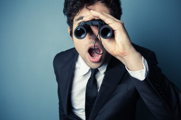 Young businessman with binoculars
