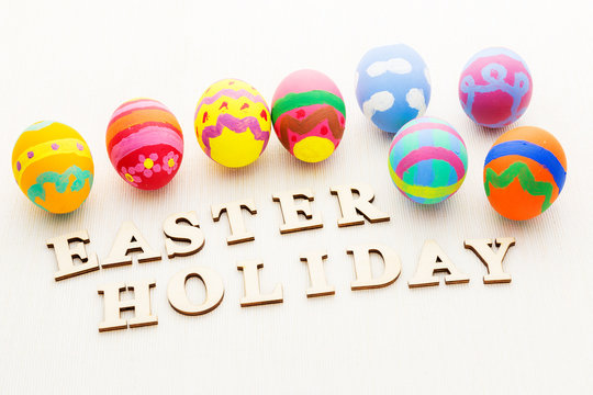 Painted easter egg with wooden text