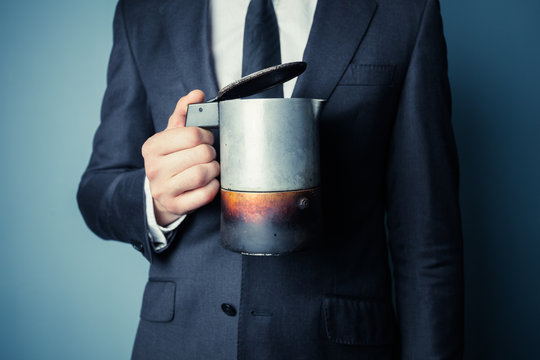 Man in suit holding a moka pot