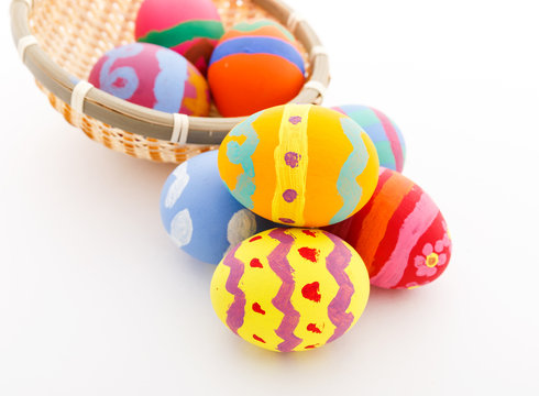 Colourful painted easter egg in basket