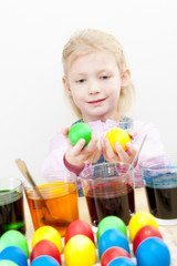 portrait of little girl during Easter eggs' coloration
