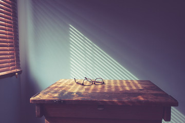 Glasses on desk by window