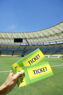 Soccer Fan Holding Two Brazil Tickets at the Stadium