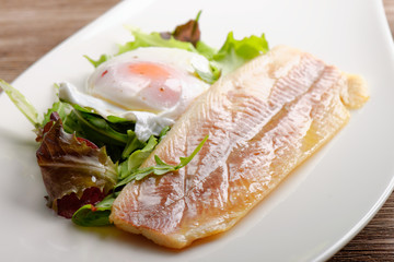Steamed fish fillet with egg, salad and fresh herbs