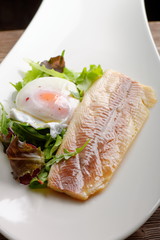 Steamed fish fillet with egg, salad and fresh herbs