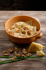 Homemade ravioli pasta with walnut, cheese and herb sauce