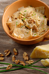 Homemade ravioli pasta with walnut, cheese and herb sauce