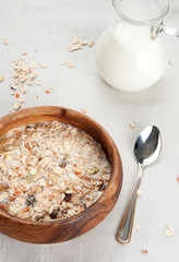 Muesli with raisin and fruits in wooden bowl