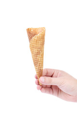 Hand holds empty ice cream corn