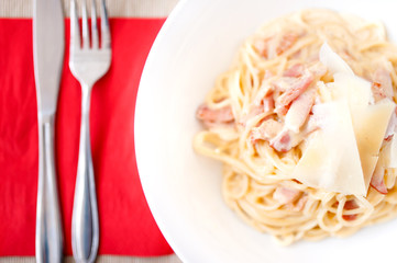 Carbonara pasta with ham, bacon and cheese