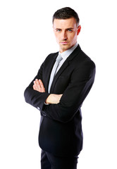 Businessman standing with arms folded over white background