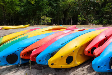 Bright kayaks on the beach. Colourful canoe