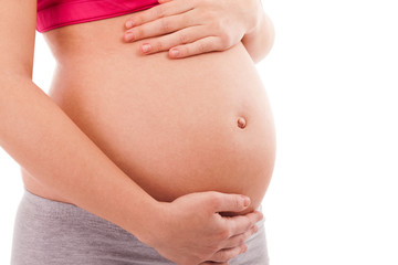 Fototapeta na wymiar Pregnant belly close up isolated