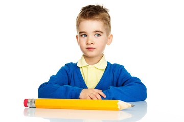 Little preschool boy  with big pencil