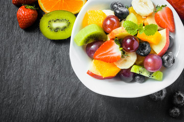 Preparing fresh fruit salad for breakfast