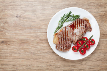Sirloin steak with rosemary and cherry tomatoes on a plate