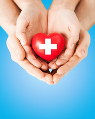 male and female hands with red heart