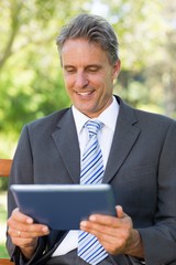 Happy businessman using digital tablet