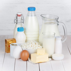 Dairy products on white wooden table still life