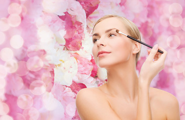 Fototapeta premium beautiful woman with makeup brush