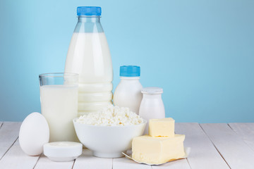 Dairy products assortment on wooden table, with place for text