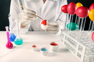 Happy Easter science people! Scientist painting Easter eggs.
