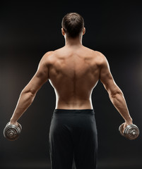 bodybuilder does exercise with dumbbells