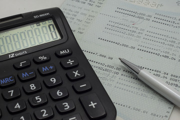 Account book, calculator and pen