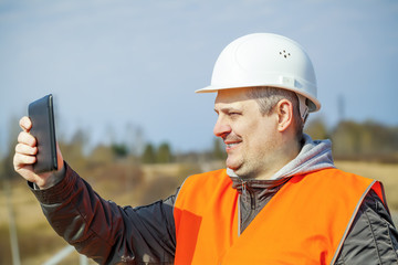 Railroad worker with tablet PC on railway