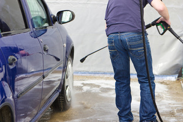 Man washing his car at self-service station