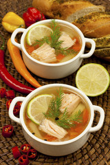 Vegetable soup with salmon in white bowl