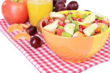 Sweet fresh fruits in bowl on table close-up