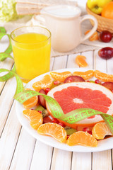 Fototapeta na wymiar Sweet fresh fruits on plate on table close-up