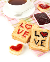 Delicious toast with jam and cup of tea on table close-up