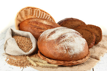 Rye bread with grains on sackcloth on table on gray background