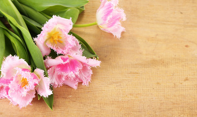 Fototapeta na wymiar Beautiful tulips on wooden background