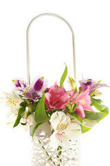 Beautiful alstroemeria  flowers in basket, isolated on white