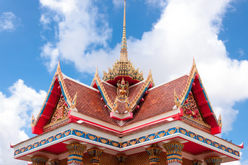 Top of traditional Thai style church with blue sky