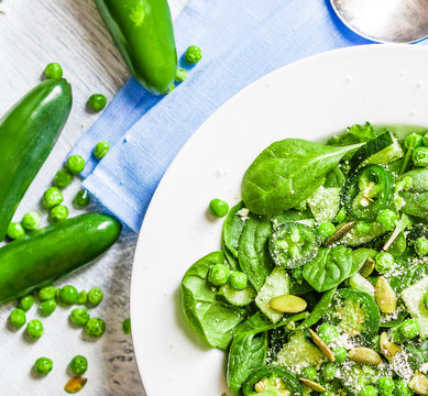 Green salad with spinach,pepper,sweet peas and parmesan on rusti