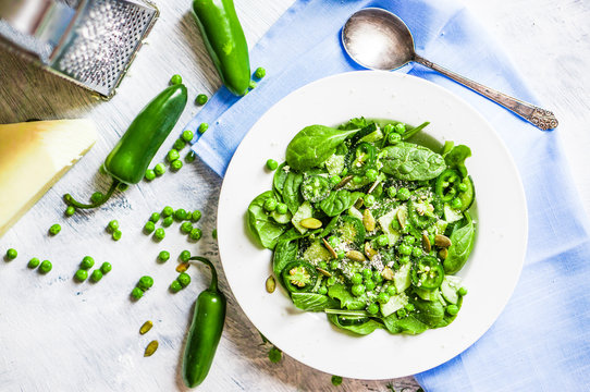 Green salad with spinach,pepper,sweet peas and parmesan on rusti