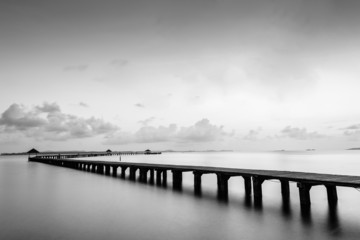 Black and white of Bridge on beach and sea wave in asia ocean
