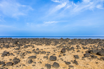 dry area with old lava stones  at the coastline