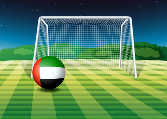 A soccer ball at the field with the UAE flag
