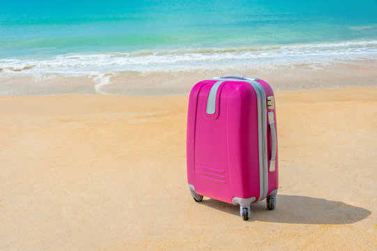 Suitcase at the sunny beach