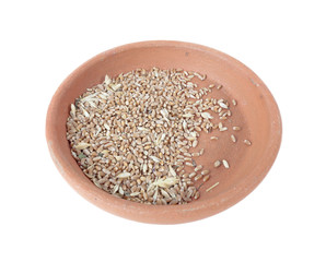 Half full of raw wheat clay bowl isolated on white