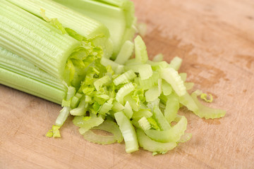 Fresh green celery on wooden board.