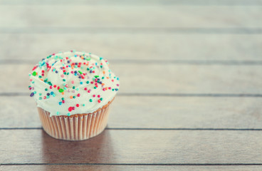 Cream cake on a wooden table.