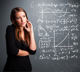 Beautiful school girl thinking about complex mathematical signs