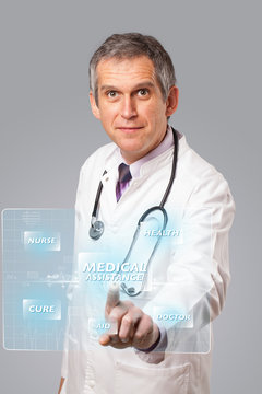 Middle aged doctor pressing modern medical type of button